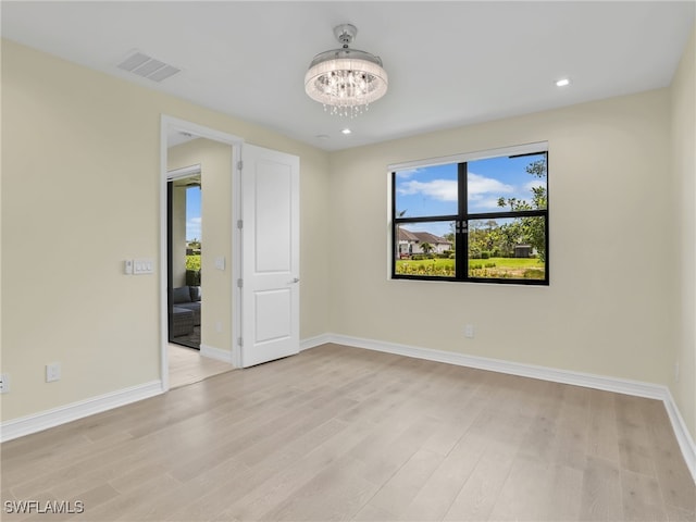7524 Carnegie Way, Naples, FL 34119 - spare room with light wood-style flooring, a chandelier, and recessed lighting