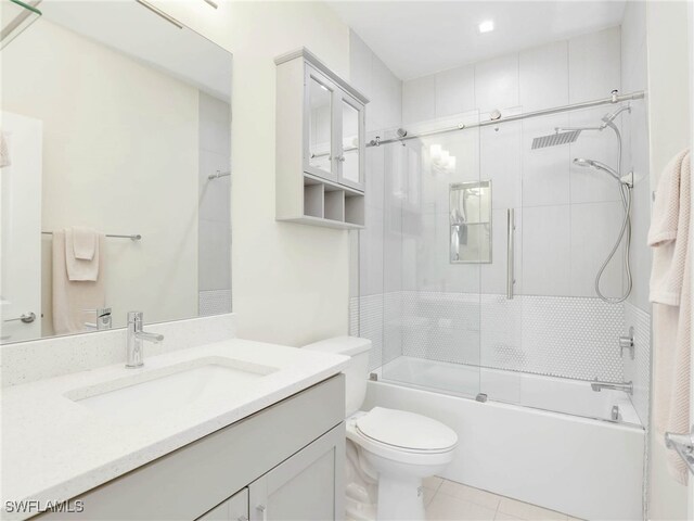 7524 Carnegie Way, Naples, FL 34119 - bathroom featuring vanity, bath / shower combo with glass door, and tile patterned flooring