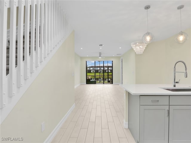 7524 Carnegie Way, Naples, FL 34119 - kitchen featuring light countertops, decorative light fixtures, recessed lighting, open floor plan, and gray cabinets