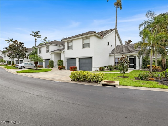 1170 Partridge Ln Unit 202, Naples, FL 34104 - view of front of house featuring an attached garage, concrete driveway, stucco siding, a tiled roof, and a front yard