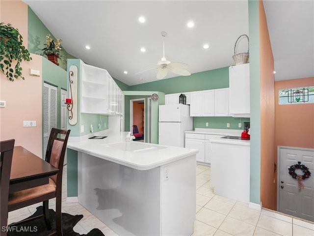 1170 Partridge Ln Unit 202, Naples, FL 34104 - kitchen with freestanding refrigerator, a peninsula, open shelves, a ceiling fan, and white cabinetry