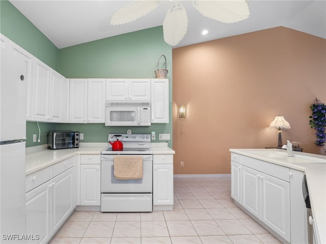 1170 Partridge Ln Unit 202, Naples, FL 34104 - kitchen featuring white appliances, vaulted ceiling, light countertops, white cabinets, and light tile patterned floors
