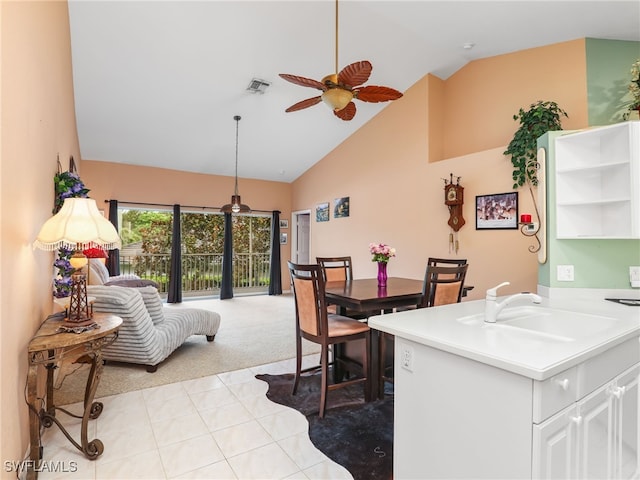 1170 Partridge Ln Unit 202, Naples, FL 34104 - kitchen with ceiling fan, high vaulted ceiling, light carpet, light tile patterned floors, and open floor plan