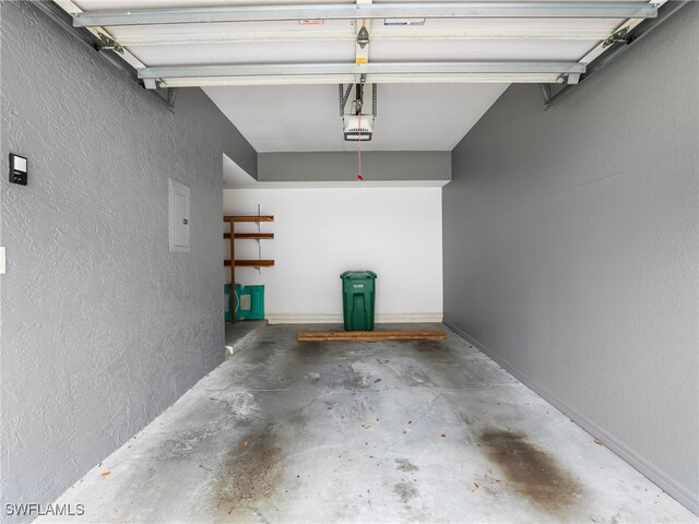1170 Partridge Ln Unit 202, Naples, FL 34104 - garage featuring a textured wall and a garage door opener