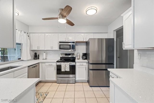 17236 Lee Rd, Fort Myers, FL 33967 - kitchen with appliances with stainless steel finishes, white cabinets, light tile patterned flooring, and light countertops