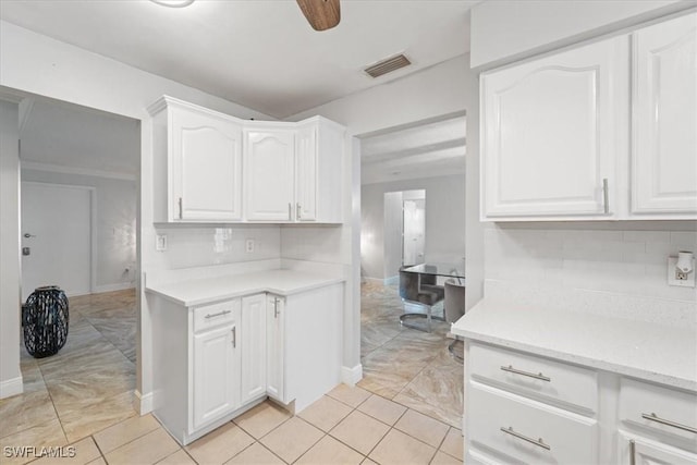 17236 Lee Rd, Fort Myers, FL 33967 - kitchen featuring light countertops, tasteful backsplash, and white cabinets