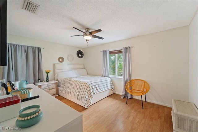 17236 Lee Rd, Fort Myers, FL 33967 - bedroom with light wood-type flooring, a textured ceiling, and ceiling fan