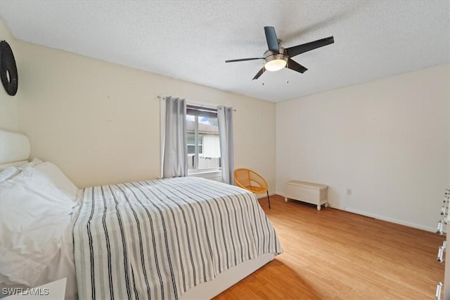 17236 Lee Rd, Fort Myers, FL 33967 - bedroom with wood finished floors, a textured ceiling, and a ceiling fan