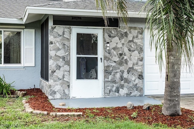 17236 Lee Rd, Fort Myers, FL 33967 - view of home's exterior featuring stone siding, roof with shingles, and stucco siding
