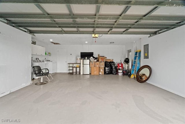 17236 Lee Rd, Fort Myers, FL 33967 - garage with washer and clothes dryer, freestanding refrigerator, electric panel, and a garage door opener