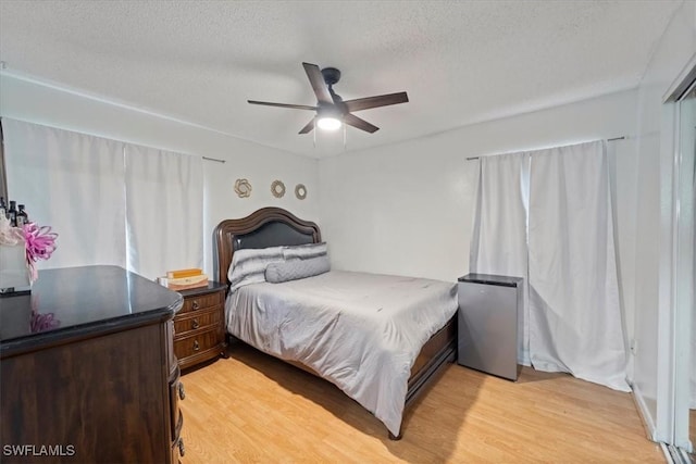 17236 Lee Rd, Fort Myers, FL 33967 - bedroom featuring light wood-style floors, a textured ceiling, and a ceiling fan
