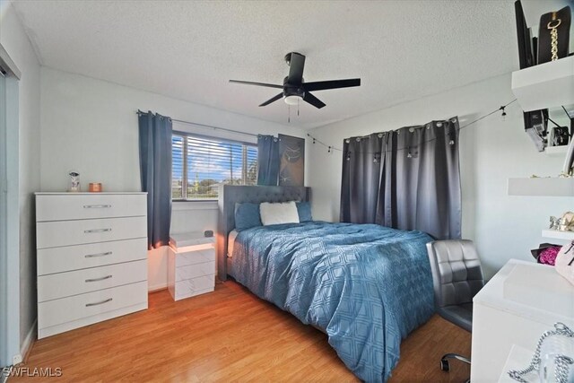 17236 Lee Rd, Fort Myers, FL 33967 - bedroom featuring wood finished floors, a textured ceiling, and ceiling fan