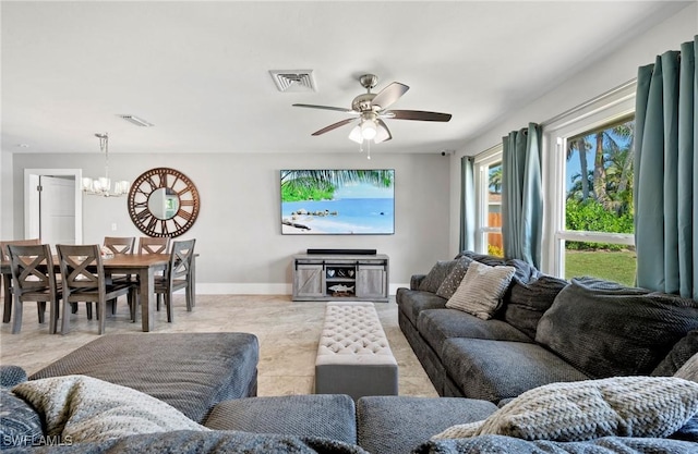 718 Coral Dr, Cape Coral, FL 33904 - living area featuring a chandelier and a ceiling fan