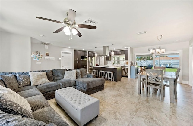 718 Coral Dr, Cape Coral, FL 33904 - living room featuring a chandelier and a ceiling fan