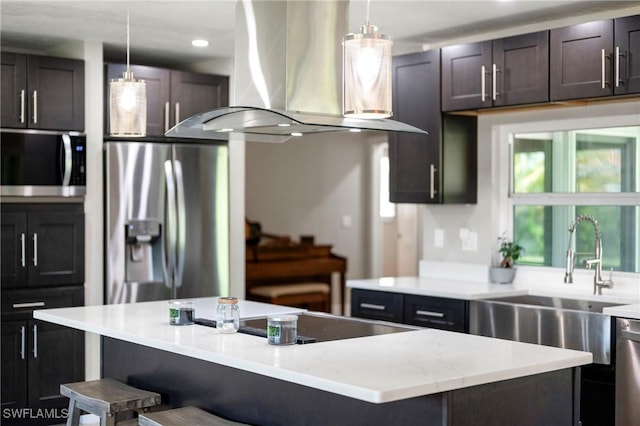 718 Coral Dr, Cape Coral, FL 33904 - kitchen featuring exhaust hood, stainless steel appliances, a breakfast bar, a kitchen island, and hanging light fixtures