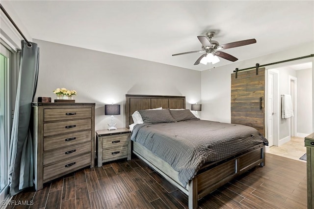 718 Coral Dr, Cape Coral, FL 33904 - bedroom featuring wood tiled floors, a barn door, and a ceiling fan