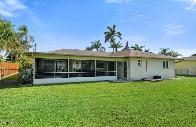 718 Coral Dr, Cape Coral, FL 33904 - rear view of property with a sunroom and stucco siding