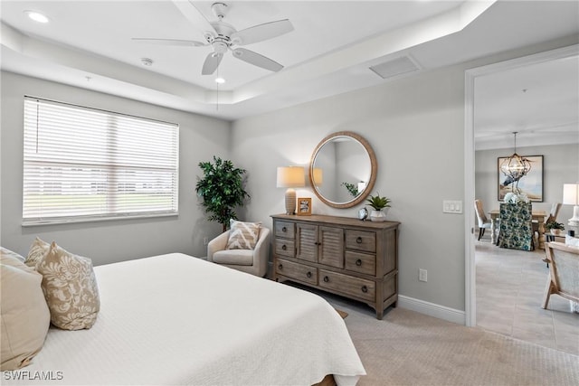 2609 Seychelles Cir Unit 1603, Naples, FL 34112 - bedroom with a raised ceiling, light colored carpet, recessed lighting, a ceiling fan, and a chandelier