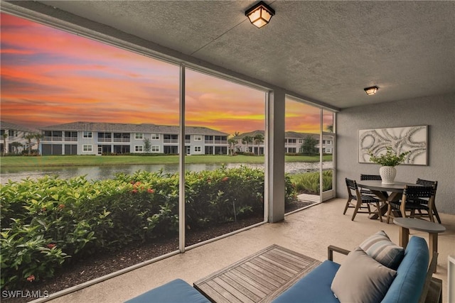 2609 Seychelles Cir Unit 1603, Naples, FL 34112 - sunroom with a water view, a residential view, and outdoor dining area