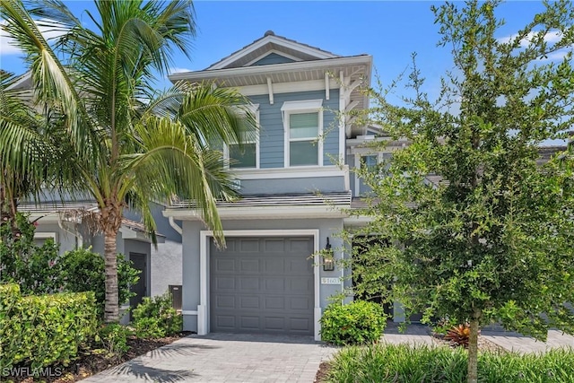 2609 Seychelles Cir Unit 1603, Naples, FL 34112 - view of front of property with a garage, stucco siding, and decorative driveway