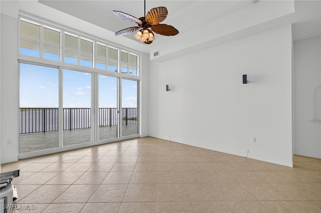 2797 1st St Unit 2004, Fort Myers, FL 33916 - spare room featuring ceiling fan, light tile patterned flooring, and a tray ceiling