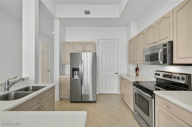 2797 1st St Unit 2004, Fort Myers, FL 33916 - kitchen featuring appliances with stainless steel finishes, light tile patterned flooring, light countertops, and light brown cabinets