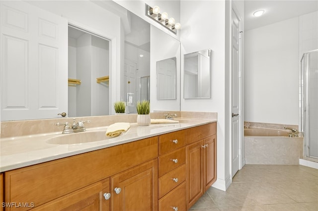 2797 1st St Unit 2004, Fort Myers, FL 33916 - bathroom featuring double vanity, a garden tub, a shower stall, tile patterned flooring, and a closet