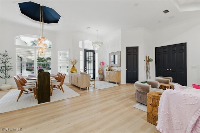 8920 Lely Island Cir, Naples, FL 34113 - bedroom featuring a chandelier, light wood-style flooring, ornamental molding, and a towering ceiling