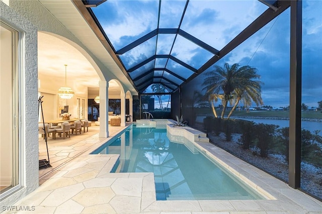 8920 Lely Island Cir, Naples, FL 34113 - outdoor pool with a patio area, glass enclosure, and a water view