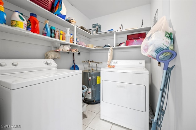 7400 College Pkwy Unit 59C, Fort Myers, FL 33907 - laundry room with washing machine and clothes dryer, light tile patterned floors, and electric water heater