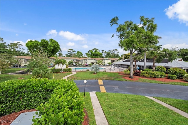 7400 College Pkwy Unit 59C, Fort Myers, FL 33907 - surrounding community with a pool and a yard