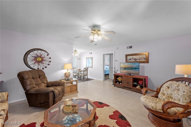 7400 College Pkwy Unit 59C, Fort Myers, FL 33907 - living room featuring ceiling fan, light tile patterned floors, and a textured ceiling