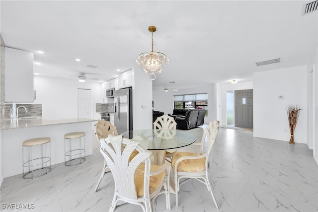 1506 SE 42nd St, Cape Coral, FL 33904 - dining space featuring light marble finish floors, recessed lighting, a chandelier, and a ceiling fan