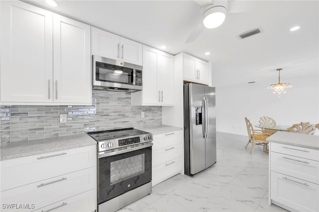1506 SE 42nd St, Cape Coral, FL 33904 - kitchen with stainless steel appliances, white cabinets, a ceiling fan, light marble finish floors, and recessed lighting