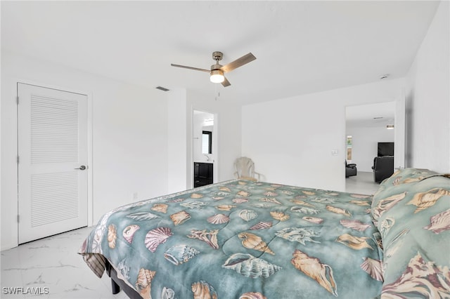 1506 SE 42nd St, Cape Coral, FL 33904 - bedroom with marble finish floors, ceiling fan, and connected bathroom