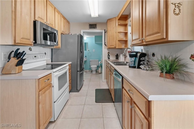 4180 Coconut Cir S, Naples, FL 34104 - kitchen with appliances with stainless steel finishes, backsplash, light tile patterned floors, light countertops, and open shelves