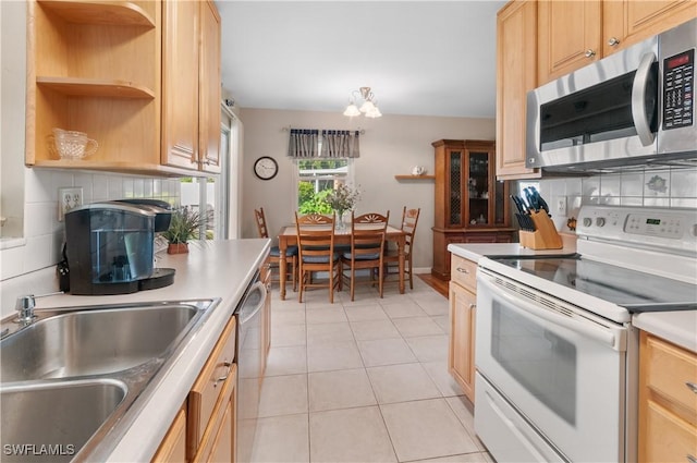 4180 Coconut Cir S, Naples, FL 34104 - kitchen with stainless steel appliances, decorative backsplash, a chandelier, and open shelves