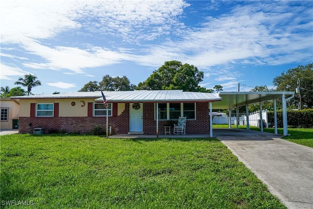 4180 Coconut Cir S, Naples, FL 34104 - view of front facade with concrete driveway, a carport, brick siding, covered porch, and stucco siding