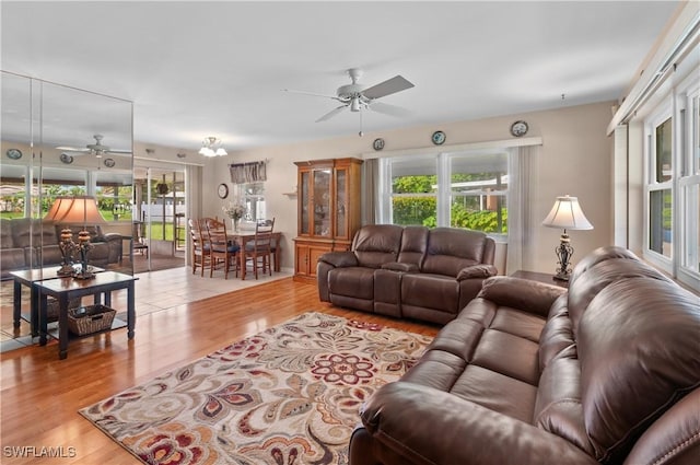 4180 Coconut Cir S, Naples, FL 34104 - living room with a ceiling fan, wood finished floors, and plenty of natural light