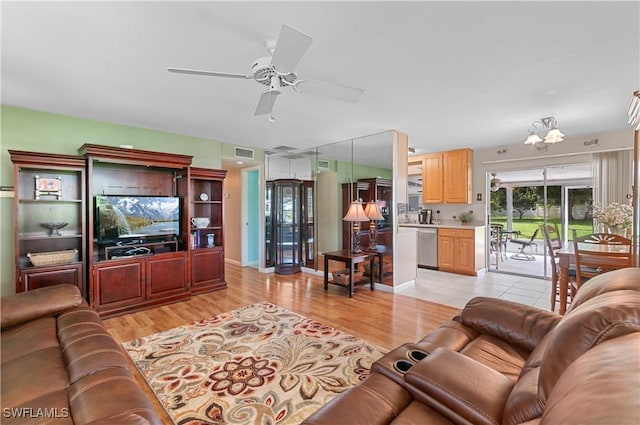 4180 Coconut Cir S, Naples, FL 34104 - living area with ceiling fan and light wood-style floors