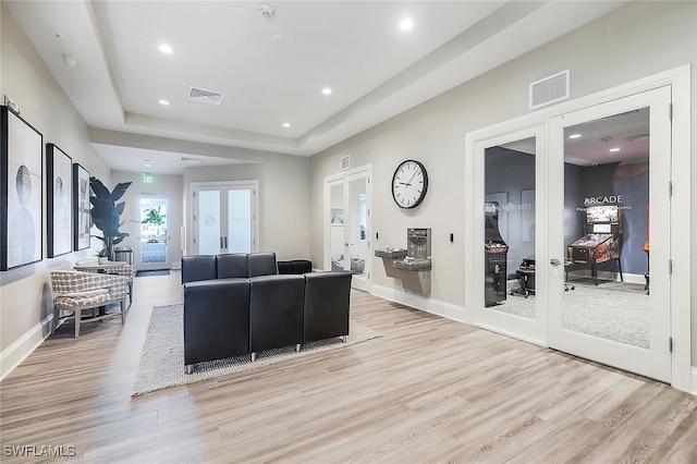 14044 Hunter Oak Dr, Fort Myers, FL 33913 - living area featuring french doors, light wood-type flooring, recessed lighting, and a tray ceiling