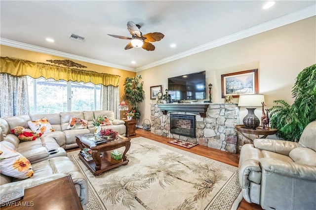 1841 Senegal Date Dr, Naples, FL 34119 - living room featuring ceiling fan, wood finished floors, ornamental molding, a stone fireplace, and recessed lighting