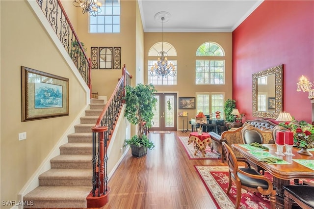 1841 Senegal Date Dr, Naples, FL 34119 - entryway with a chandelier, stairs, a high ceiling, crown molding, and wood finished floors
