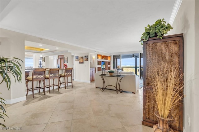 4753 Estero Blvd Unit 1405, Fort Myers Beach, FL 33931 - living room featuring ornamental molding, light tile patterned floors, a raised ceiling, and floor to ceiling windows