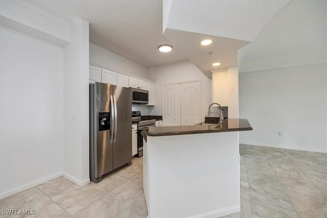 12980 Positano Cir Unit 306, Naples, FL 34105 - kitchen featuring appliances with stainless steel finishes, white cabinetry, a peninsula, recessed lighting, and dark stone countertops