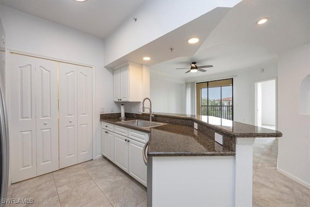 12980 Positano Cir Unit 306, Naples, FL 34105 - kitchen with a peninsula, ceiling fan, white cabinetry, dark stone counters, and recessed lighting