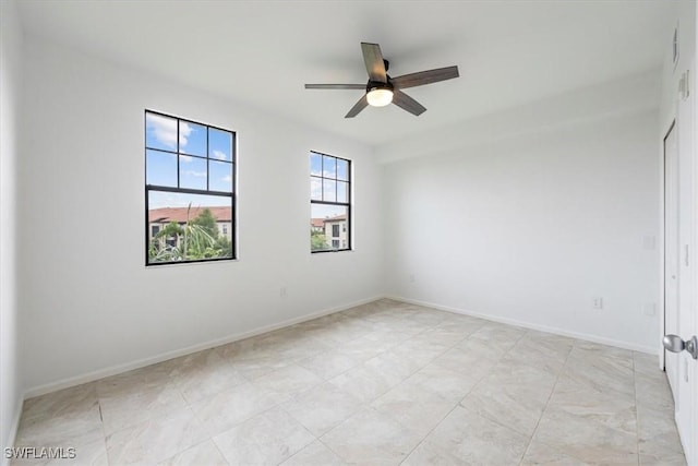 12980 Positano Cir Unit 306, Naples, FL 34105 - empty room with a ceiling fan and baseboards