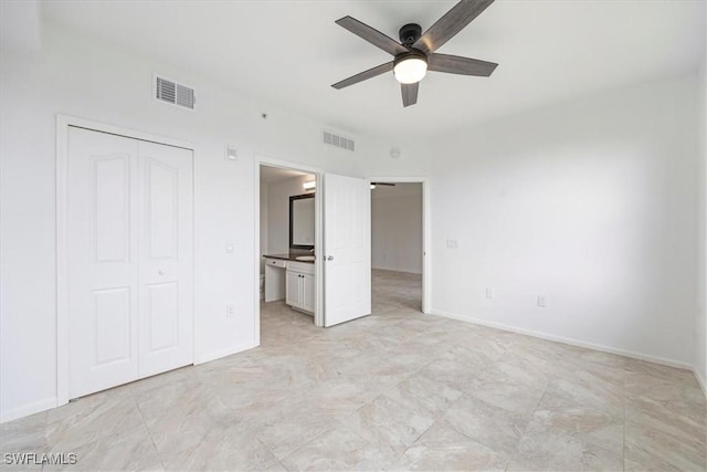 12980 Positano Cir Unit 306, Naples, FL 34105 - unfurnished bedroom featuring a closet, ensuite bath, and ceiling fan