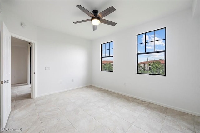 12980 Positano Cir Unit 306, Naples, FL 34105 - empty room with a ceiling fan, light tile patterned flooring, and a smoke detector