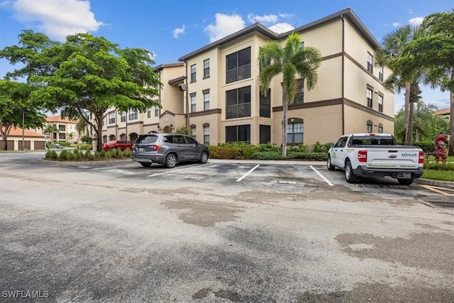 12980 Positano Cir Unit 306, Naples, FL 34105 - view of property with uncovered parking